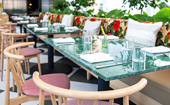 tables with chairs and bench seating set up for dinner